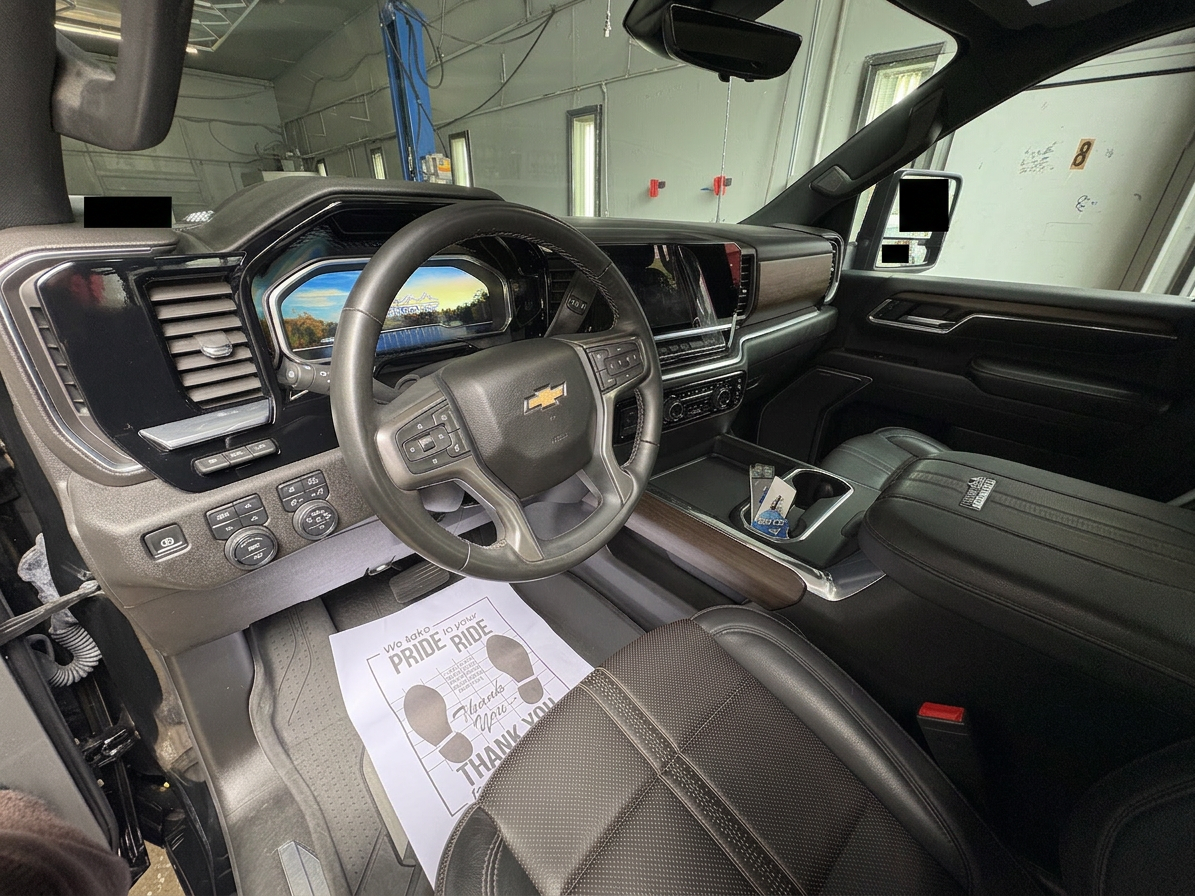 Detailer brushing leather interior of a luxury car
